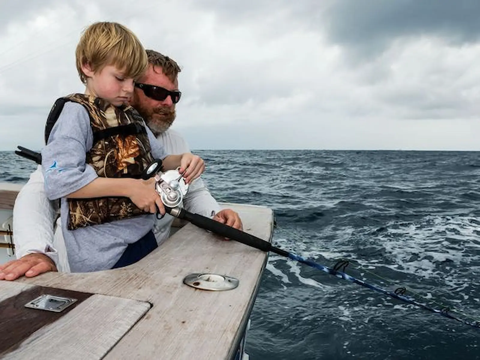 Family with children fishing on a private charter off Quepos, Costa Rica